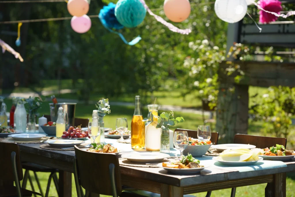 Outdoor table with food, drinks, and lanterns — a vibrant scene perfect for alfresco dining in Singapore.
